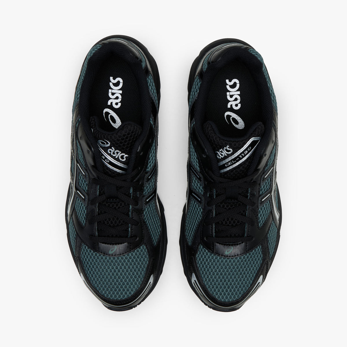 ASICS GEL-1130. Top-down overhead view of a pair of sneakers displaying dusty fern green mesh toe boxes, black synthetic overlays, black laces, padded collars, and dark branded insoles.