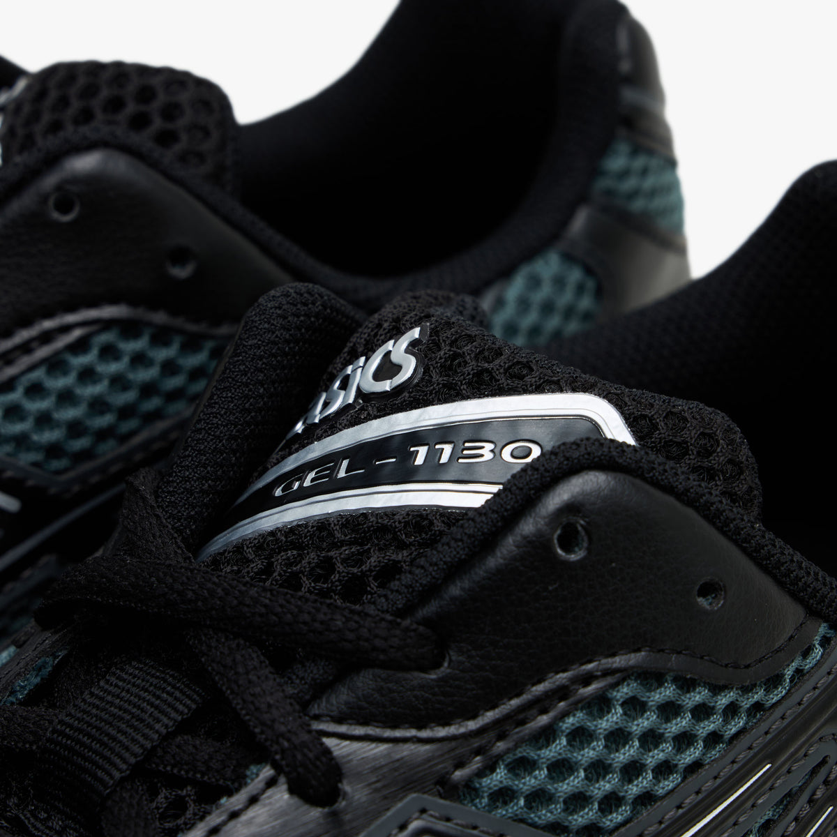 ASICS GEL-1130. Close-up view of the collar and throat region highlighting dusty fern mesh, black synthetic eyestays, black laces, and tongue badge with silver ASICS GEL-1130 branding.