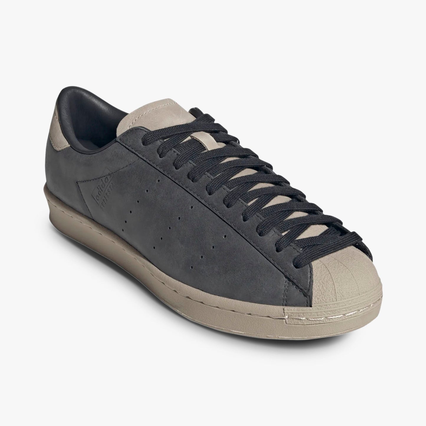 adidas Superstar Vintage Short Shell. Three-quarter view of Carbon leather sneakers showing Wonder Beige shell toe and black laces.