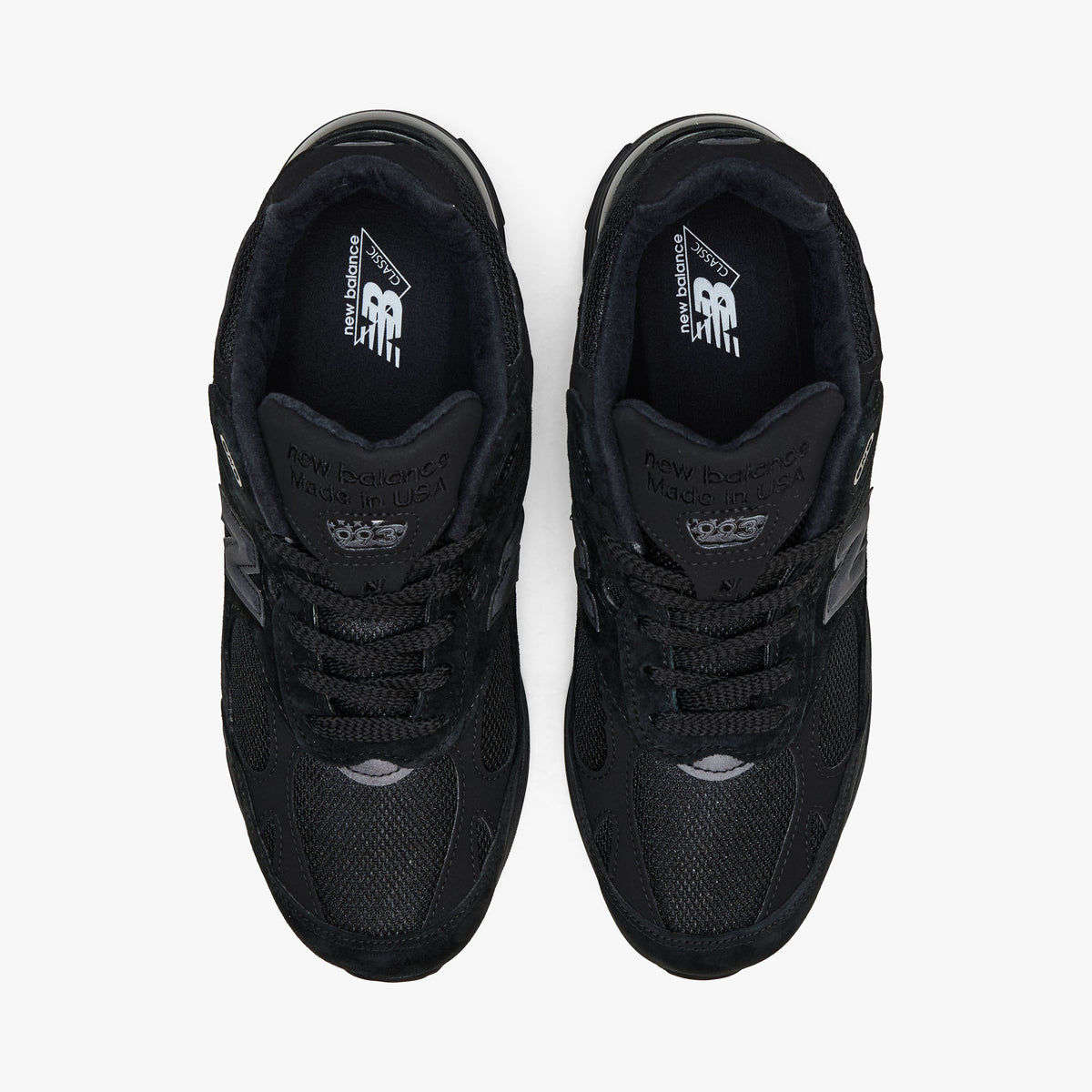 New Balance Made In USA 993. Top-down view showcasing all-black mesh toe boxes, matching lacing layout, padded collar lining, and branded insoles.