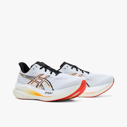 ASICS SONICBLAST 2. Three-quarter view of a pair of performance running shoes showing white mesh uppers, black and stadium orange side stripes, black laces, and sculpted orange-gradient foam midsoles. 