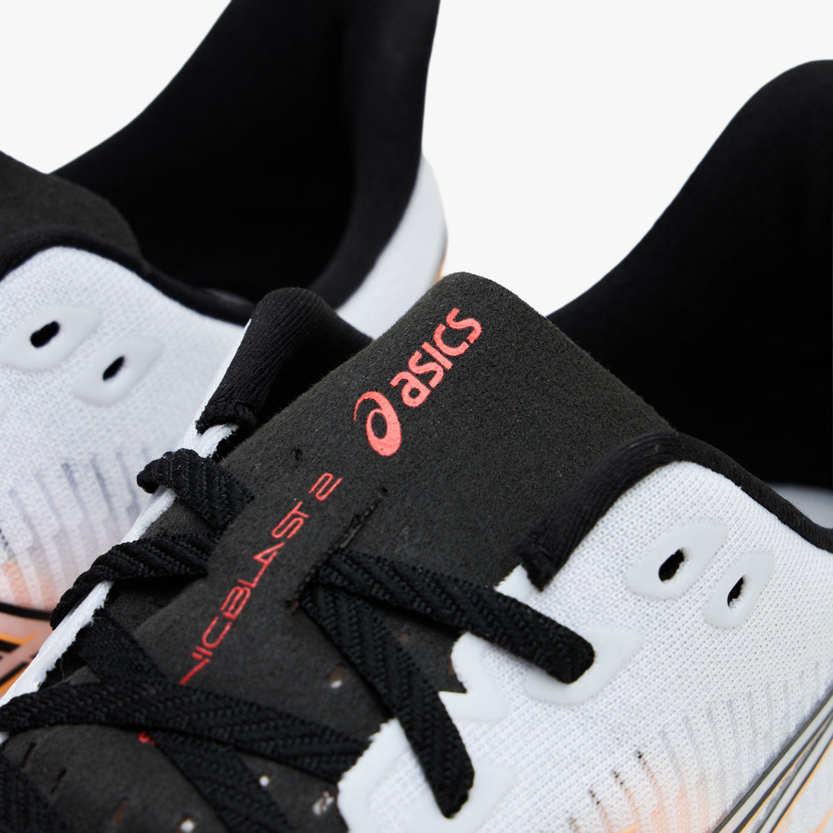 ASICS SONICBLAST 2. Close-up view of the throat and tongue highlighting black laces, white eyelets, and black tongue ribbon with stadium orange ASICS logo and SONICBLAST 2 text. 