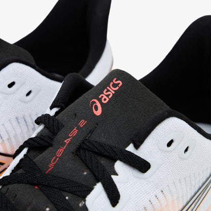 ASICS SONICBLAST 2. Close-up view of the throat and tongue highlighting black laces, white eyelets, and black tongue ribbon with stadium orange ASICS logo and SONICBLAST 2 text. 