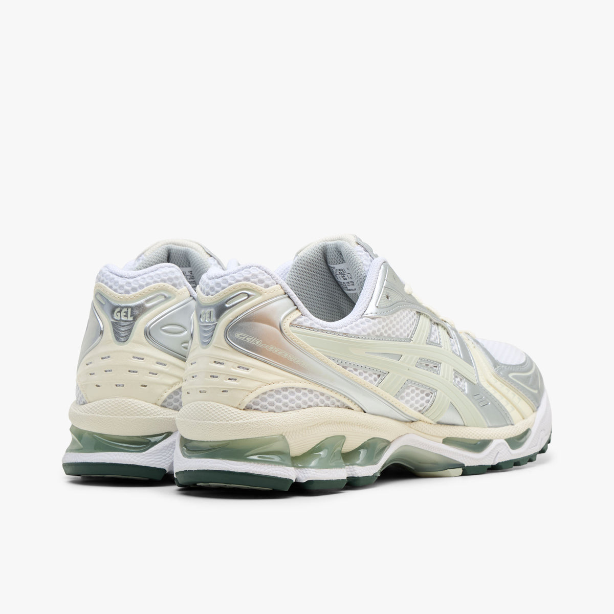 ASICS GEL-KAYANO 14. Rear three-quarter view showing white mesh heel collars, light sage synthetic heel overlays, silver accents, and white GEL-cushioned midsoles with visible green GEL pods. 