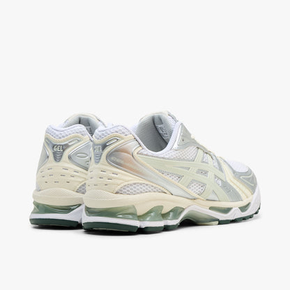 ASICS GEL-KAYANO 14. Rear three-quarter view showing white mesh heel collars, light sage synthetic heel overlays, silver accents, and white GEL-cushioned midsoles with visible green GEL pods. 