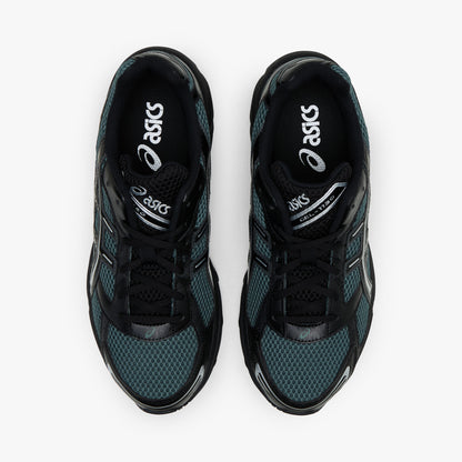 ASICS GEL-1130. Top-down overhead view of a pair of sneakers displaying dusty fern green mesh toe boxes, black synthetic overlays, black laces, padded collars, and dark branded insoles. 