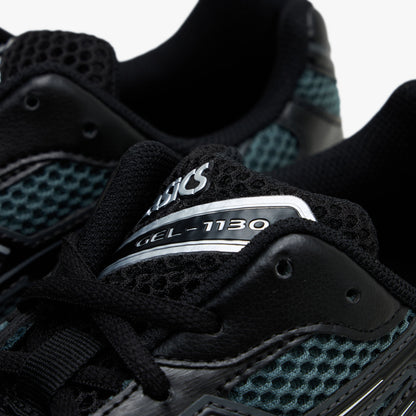 ASICS GEL-1130. Close-up view of the collar and throat region highlighting dusty fern mesh, black synthetic eyestays, black laces, and tongue badge with silver ASICS GEL-1130 branding. 