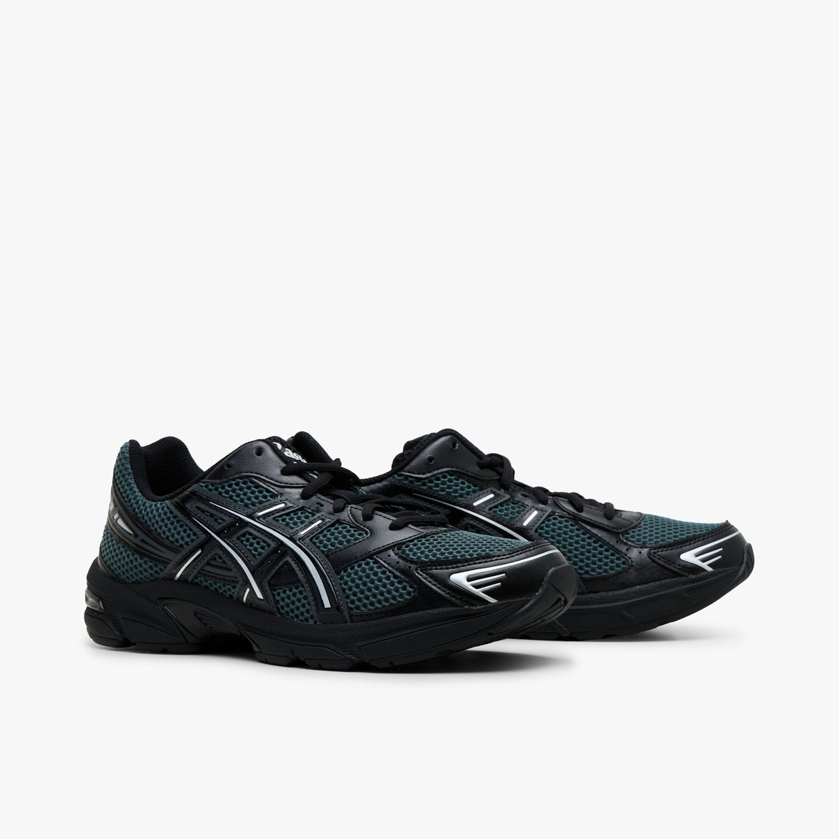 ASICS GEL-1130. Three-quarter view of a pair of running sneakers displaying dusty fern green mesh uppers, black synthetic overlays, silver Tiger Stripes, black laces, and black cushioned midsoles. 