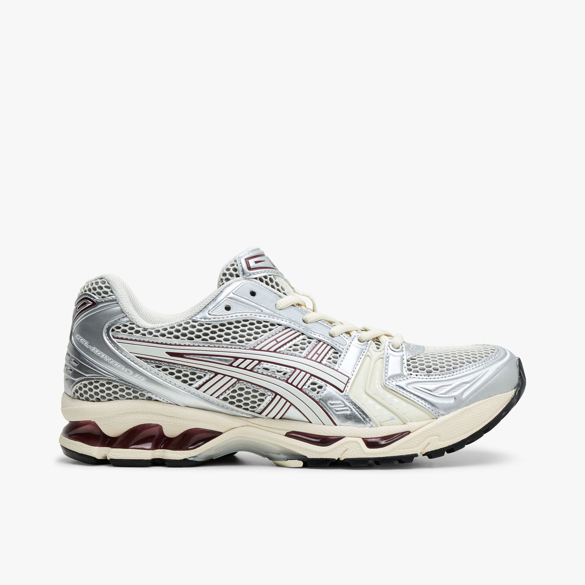 ASICS GEL-KAYANO 14. Side view of Ivory and metallic silver running shoes with burgundy accents and GEL cushioned midsole. 
