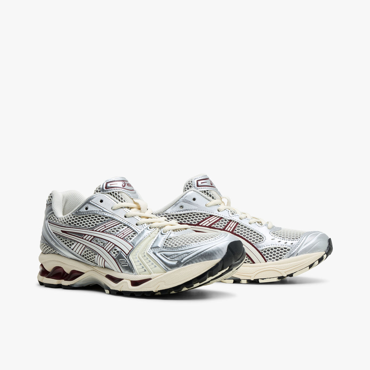 ASICS GEL-KAYANO 14. Three-quarter view of Ivory mesh running shoes showing metallic overlays and Cream lace closure. 