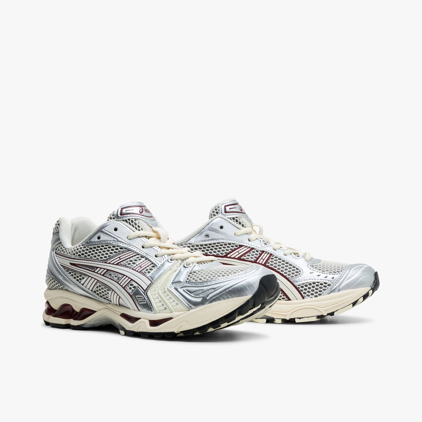 ASICS GEL-KAYANO 14. Three-quarter view of Ivory mesh running shoes showing metallic overlays and Cream lace closure. 