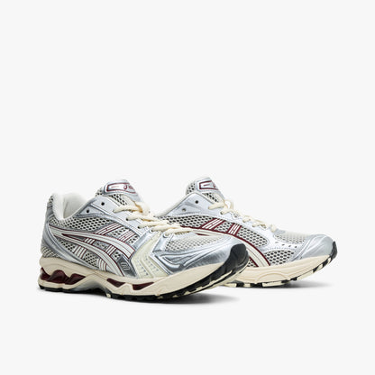 ASICS GEL-KAYANO 14. Three-quarter view of Ivory mesh running shoes showing metallic overlays and Cream lace closure. 