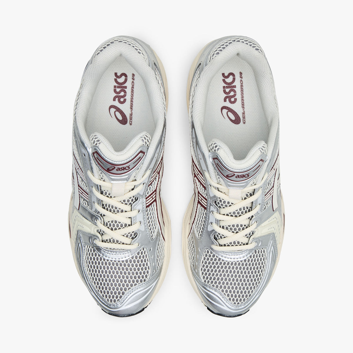 ASICS GEL-KAYANO 14. Top view of pair of silver running shoes showing cream mesh toe box, textile lining, cream laces, and padded collar. 