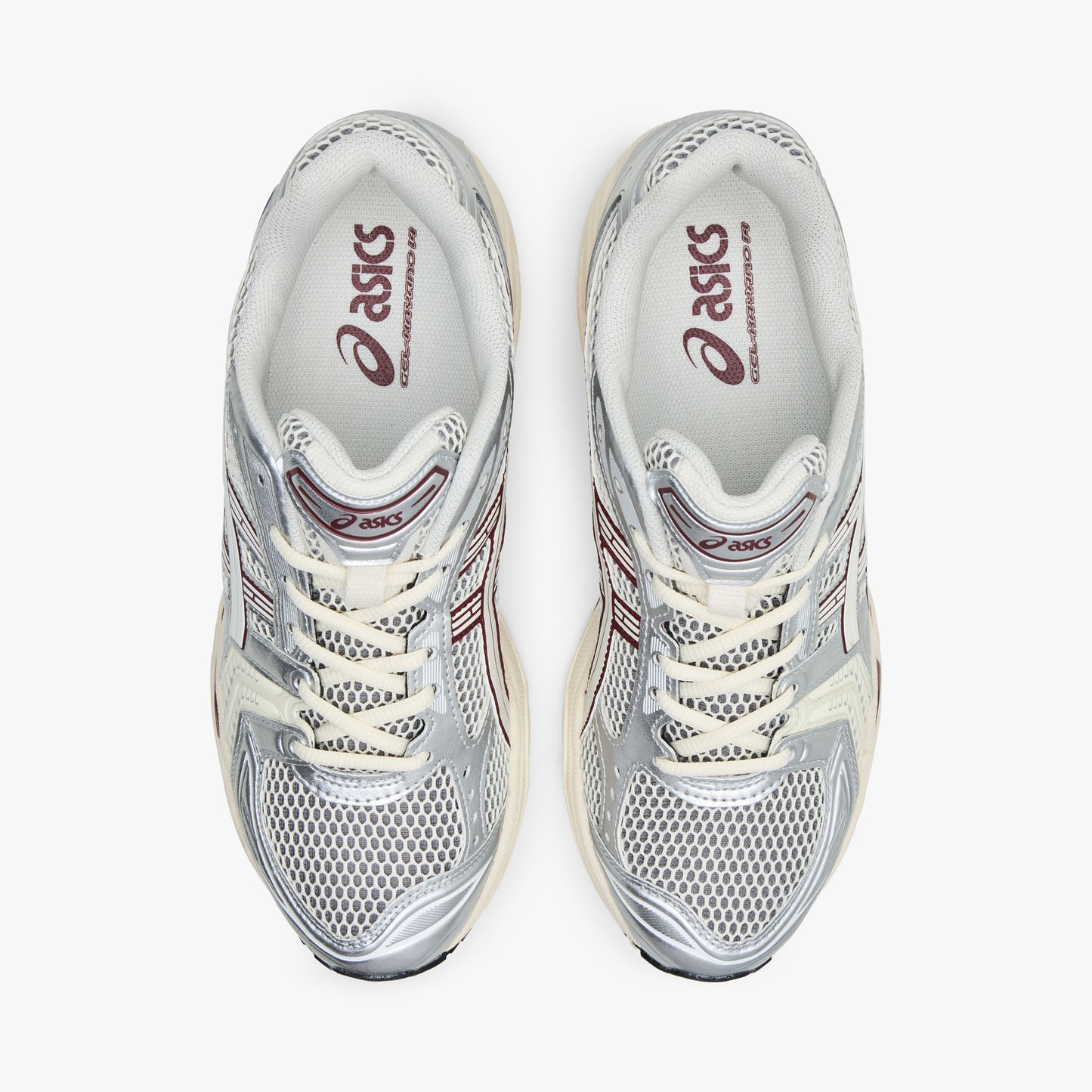 ASICS GEL-KAYANO 14. Top view of pair of silver running shoes showing cream mesh toe box, textile lining, cream laces, and padded collar. 