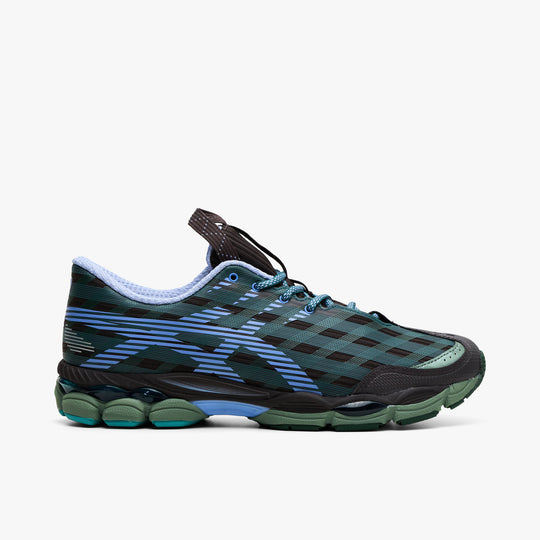 Asics US8-S GEL-SJ33. Side view of roasted coffee and periwinkle sneaker with patterned mesh upper, layered overlays and segmented green sole.