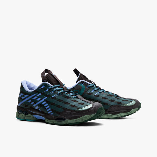 Asics US8-S GEL-SJ33. Three-quarter view of roasted coffee and periwinkle sneakers with teal laces, patterned uppers and sculpted soles.