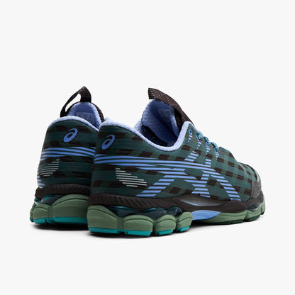 Asics US8-S GEL-SJ33. Rear three-quarter view of roasted coffee and periwinkle sneakers with layered heel panels, blue accents and green soles.