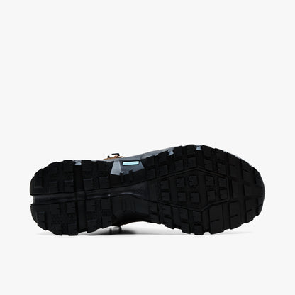 On Cloudrock Mid Waterproof. Bottom view featuring black Missiongrip rubber outsole with aggressive multidirectional traction lugs and blue Speedboard shank accent. 