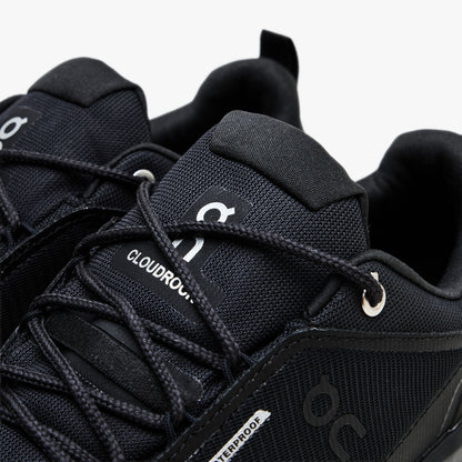 On Cloudrock Low Waterproof. Close-up view showcasing black lacing system, metallic top eyelets, tongue pull tab, and silver On logo branding. 
