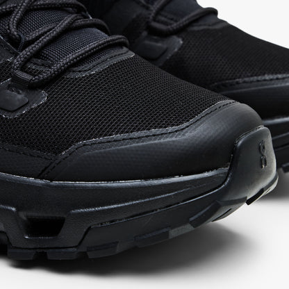 On Cloudrock Low Waterproof. Close-up view highlighting reinforced rubber toe cap, breathable black mesh upper, and protective mudguard overlay. 