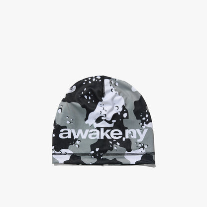 Awake NY Camo Crown Skully. Front view of a skullcap beanie featuring an all-over black, grey, and white desert camouflage pattern with white "awake ny" logo print across the front band. 