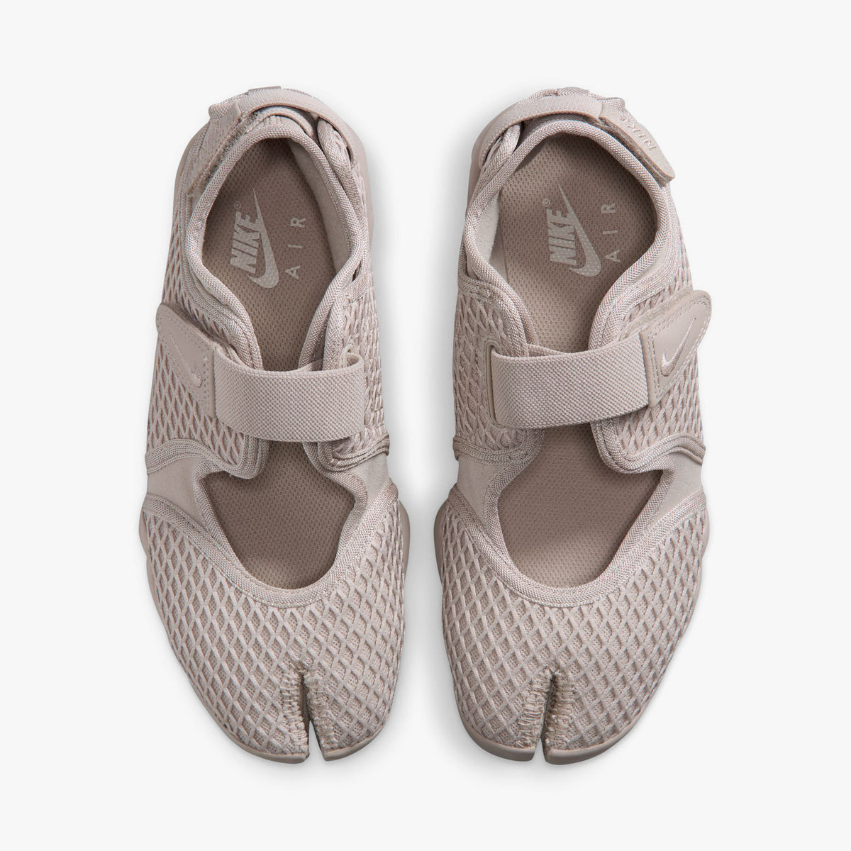 Nike Women's Air Rift. Top view of pair of Cream II split-toe shoes showing midfoot hook-and-loop straps, textile lining, and white inner sole logos. 