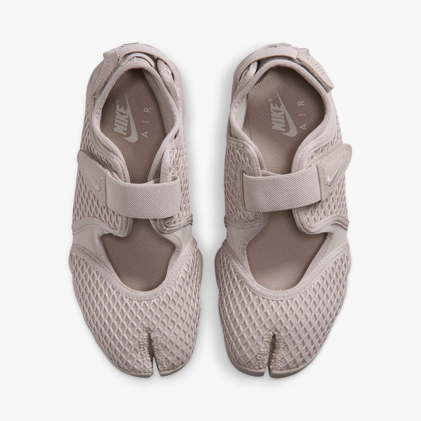 Nike Women's Air Rift. Top view of pair of Cream II split-toe shoes showing midfoot hook-and-loop straps, textile lining, and white inner sole logos. 