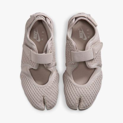 Nike Women's Air Rift. Top view of pair of Cream II split-toe shoes showing midfoot hook-and-loop straps, textile lining, and white inner sole logos. 