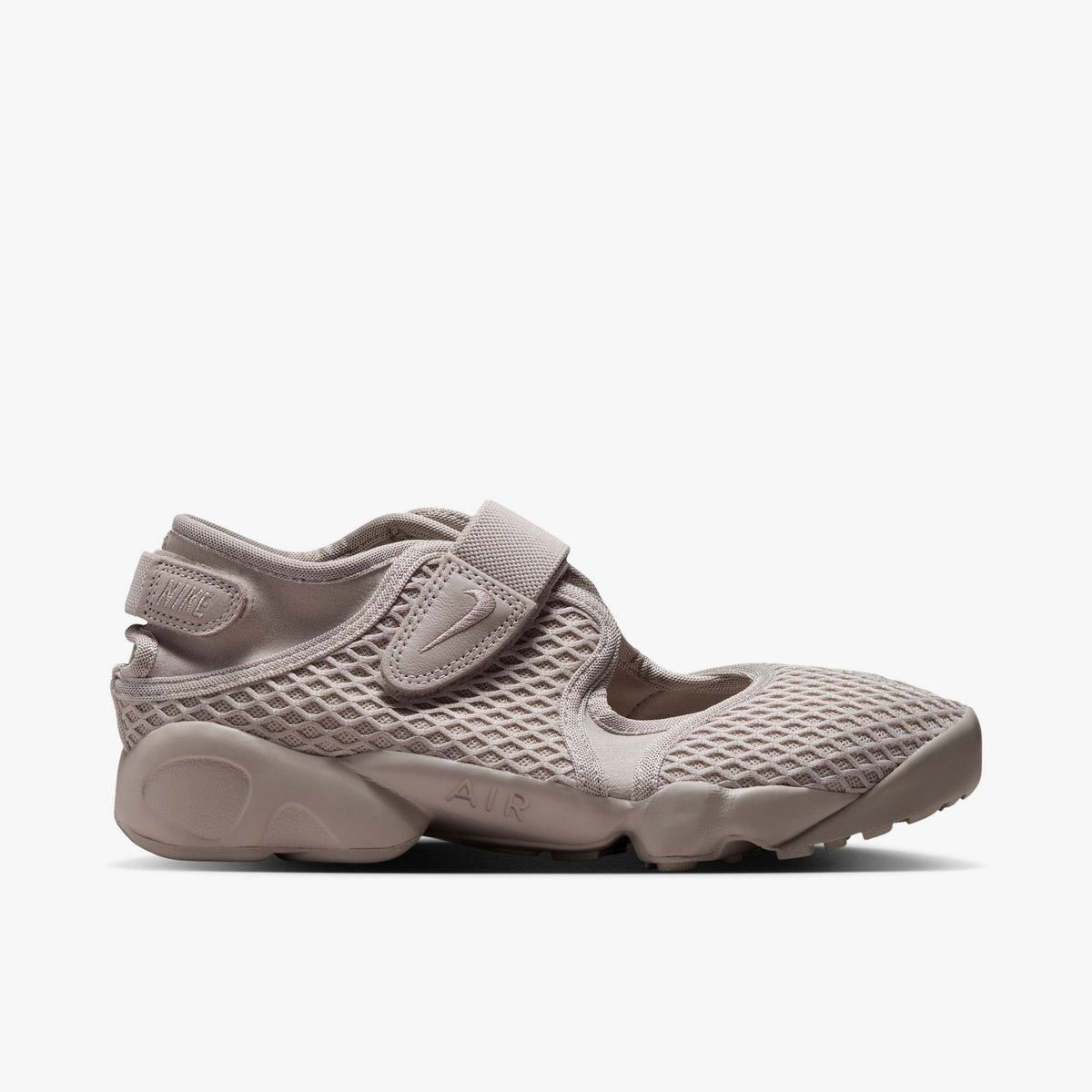 Nike Women's Air Rift. Side view of Cream II split-toe shoes with textured mesh upper, midfoot strap, and chunky foam midsole with AIR debossing. 