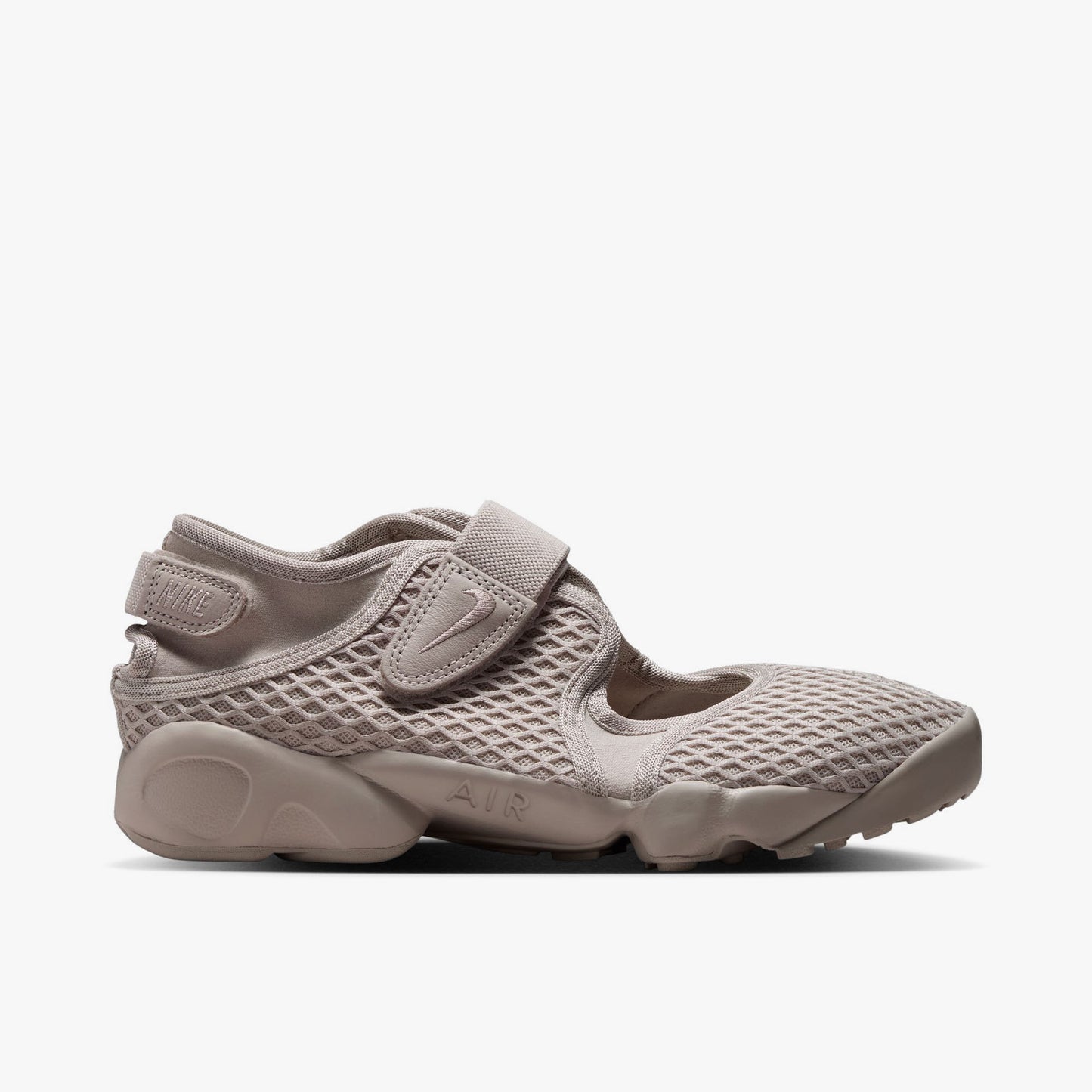 Nike Women's Air Rift. Side view of Cream II split-toe shoes with textured mesh upper, midfoot strap, and chunky foam midsole with AIR debossing. 