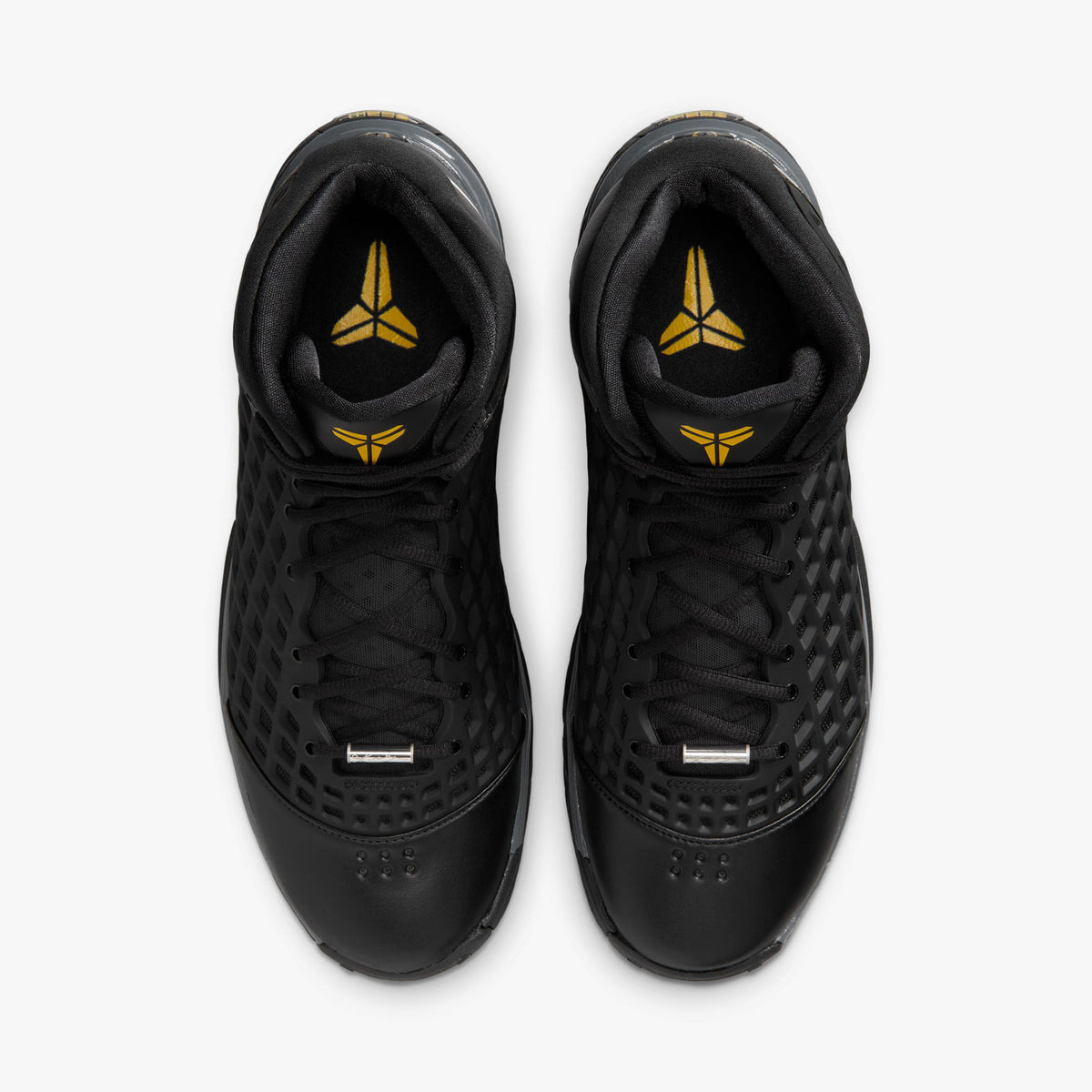 Nike Kobe III Protro. Overhead top-down view of pair of high-top basketball shoes showing black diamond net uppers, silver lace dubraes, black laces, and yellow Kobe Sheath branding on the insoles. 