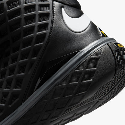 Nike Kobe III Protro. Close-up rear view of the ankle collar showing padded black lining, white Swoosh logo wrap, and interior tongue tag featuring Kobe graphics. 