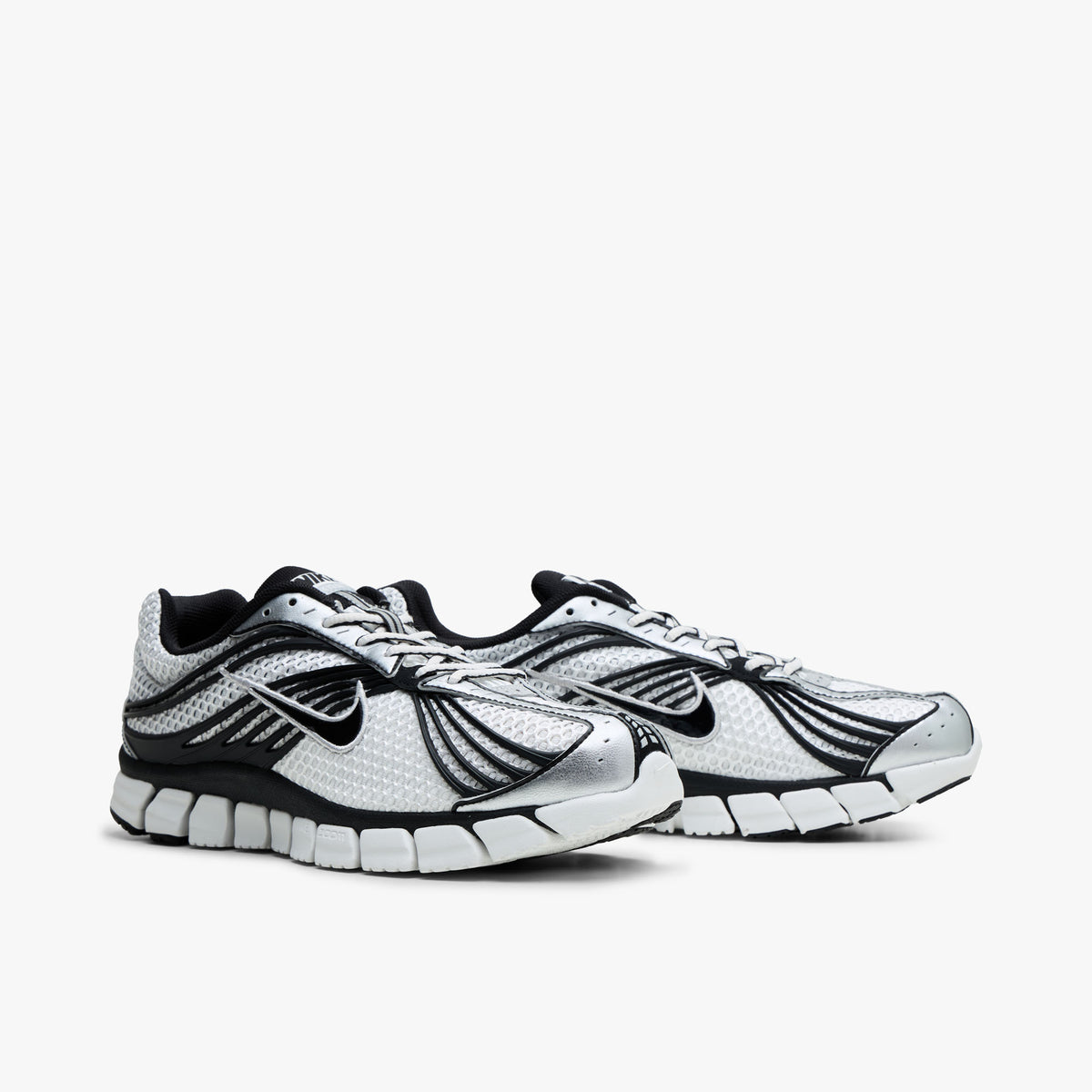 Nike Zoom Skylon 11. Three-quarter view of Summit White and Black mesh running shoes showing curved side cage design and lace closure. 