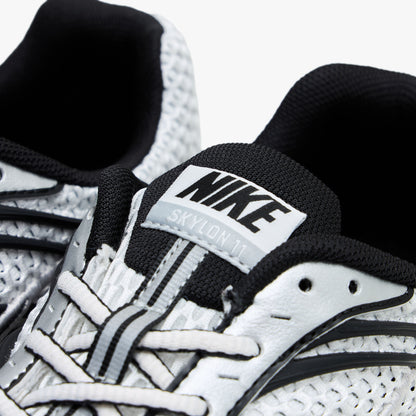 Nike Zoom Skylon 11. Close-up of Black padded collar, white laces, and woven Nike tongue label on mesh upper.