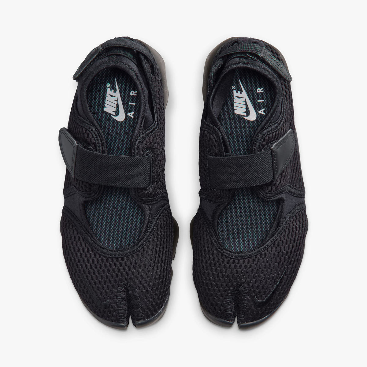 Nike Women's Air Rift Mesh. Top view of pair of black split-toe shoes showing midfoot straps, textile lining, and white Nike Air inner sole branding. 