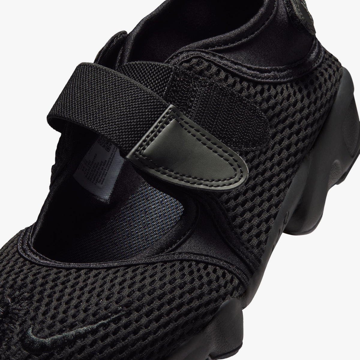 Nike Women's Air Rift Mesh. Close-up of black mesh upper, split-toe box design, velcro hook-and-loop closure, and embroidered Nike Swoosh on the strap. 