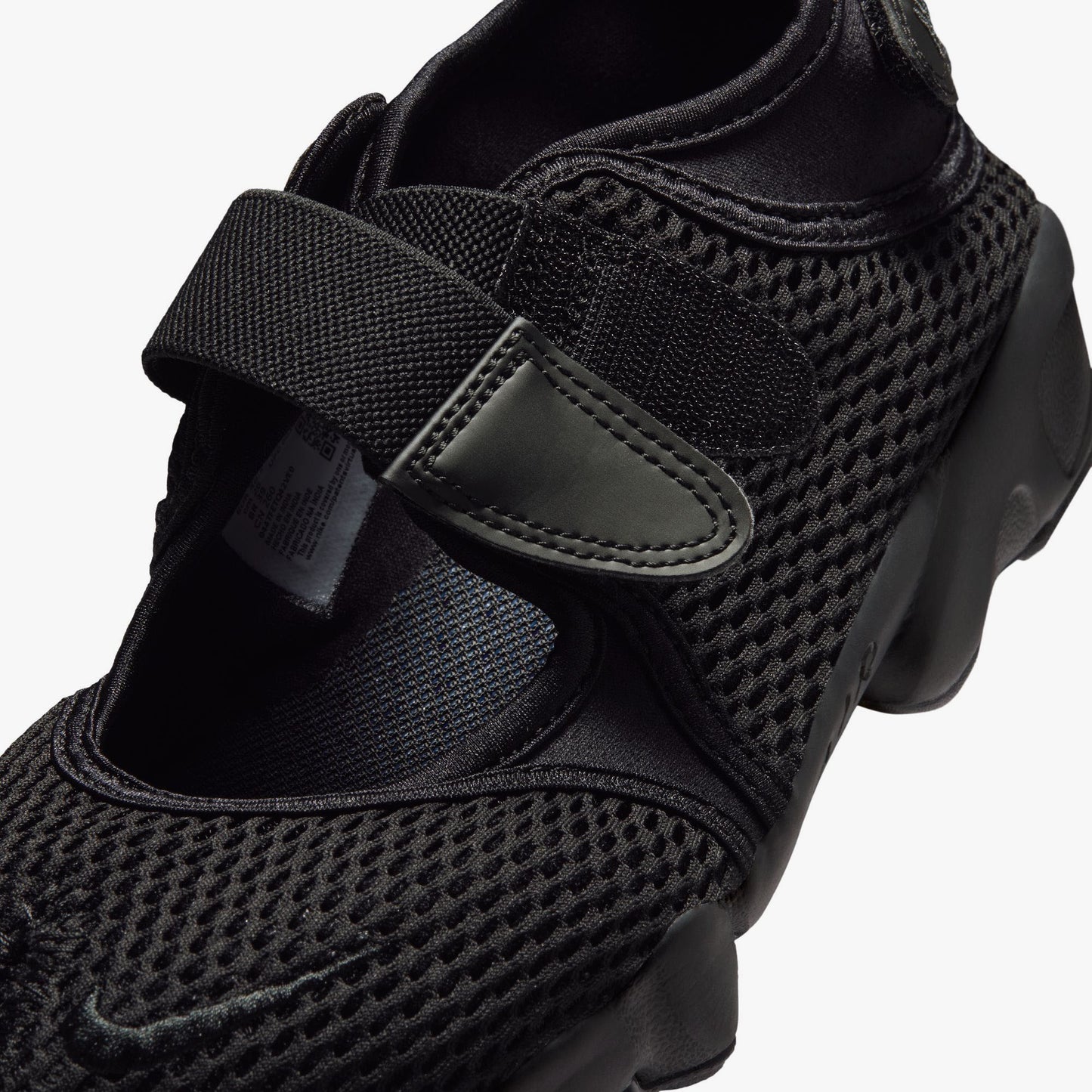 Nike Women's Air Rift Mesh. Close-up of black mesh upper, split-toe box design, velcro hook-and-loop closure, and embroidered Nike Swoosh on the strap. 