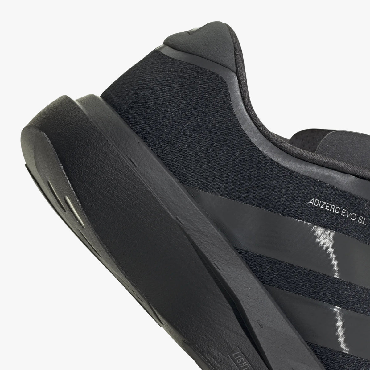 adidas adizero EVO SL Zip-Up. Close-up of Black padded heel collar, side adizero branding, and thick cushioned foam heel. 