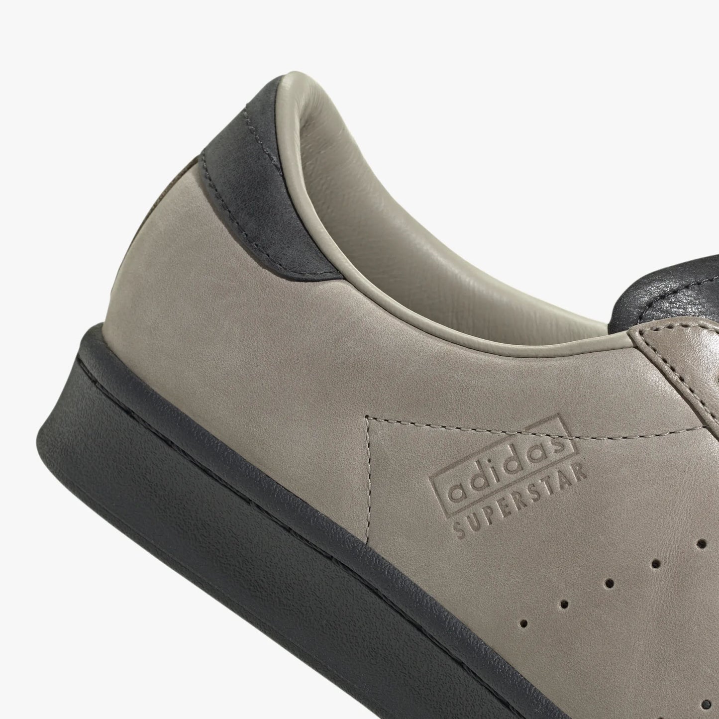 adidas Superstar Vintage Short Shell. Close-up of Carbon leather heel tab, Wonder Beige side paneling, and Carbon rubber cupsole. 