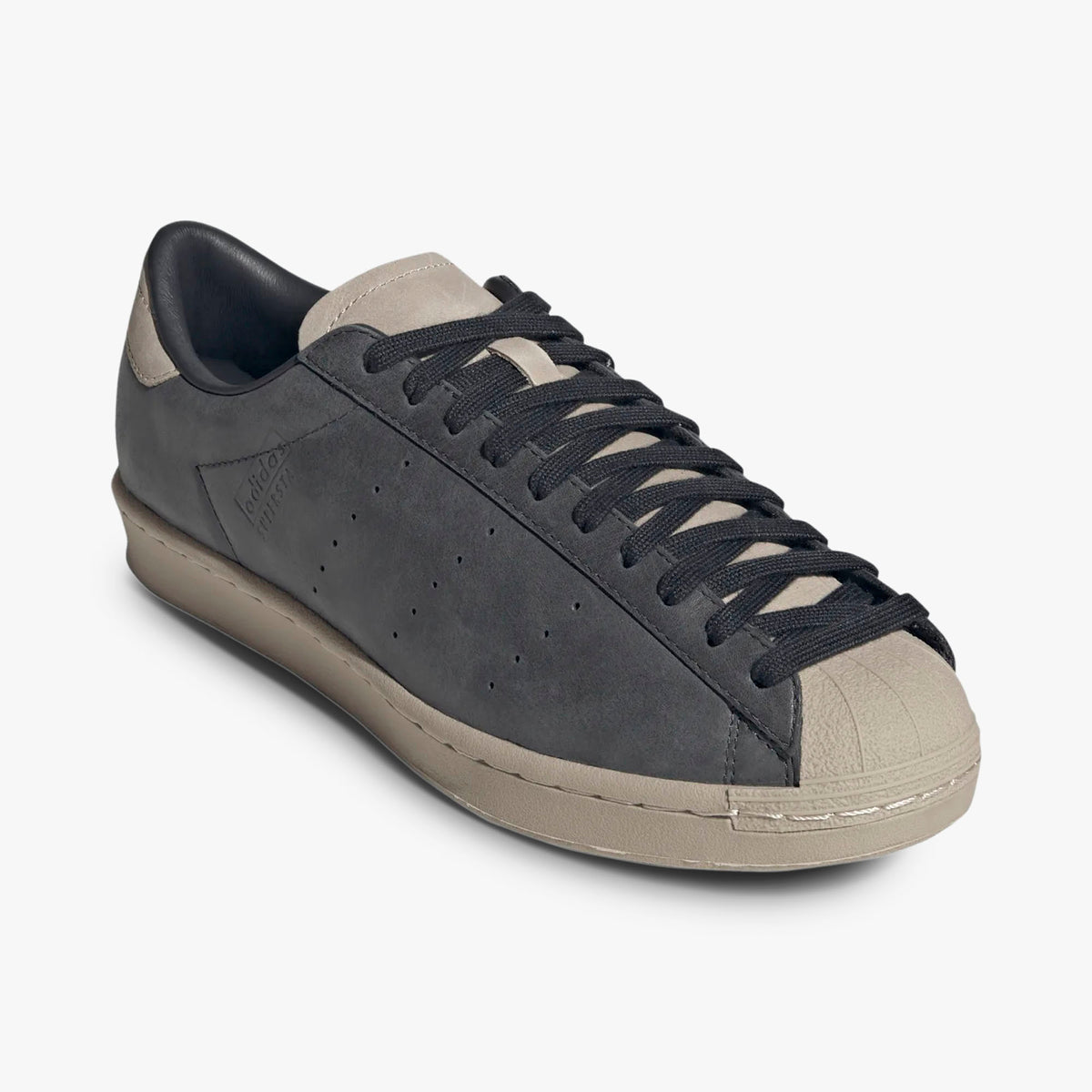 adidas Superstar Vintage Short Shell. Three-quarter view of Carbon leather sneakers showing Wonder Beige shell toe and black laces. 