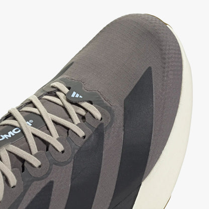 adidas adizero EVO SL. Close-up of Charcoal woven upper showing light grey laces, light blue accent loop, and dark three-stripes. 