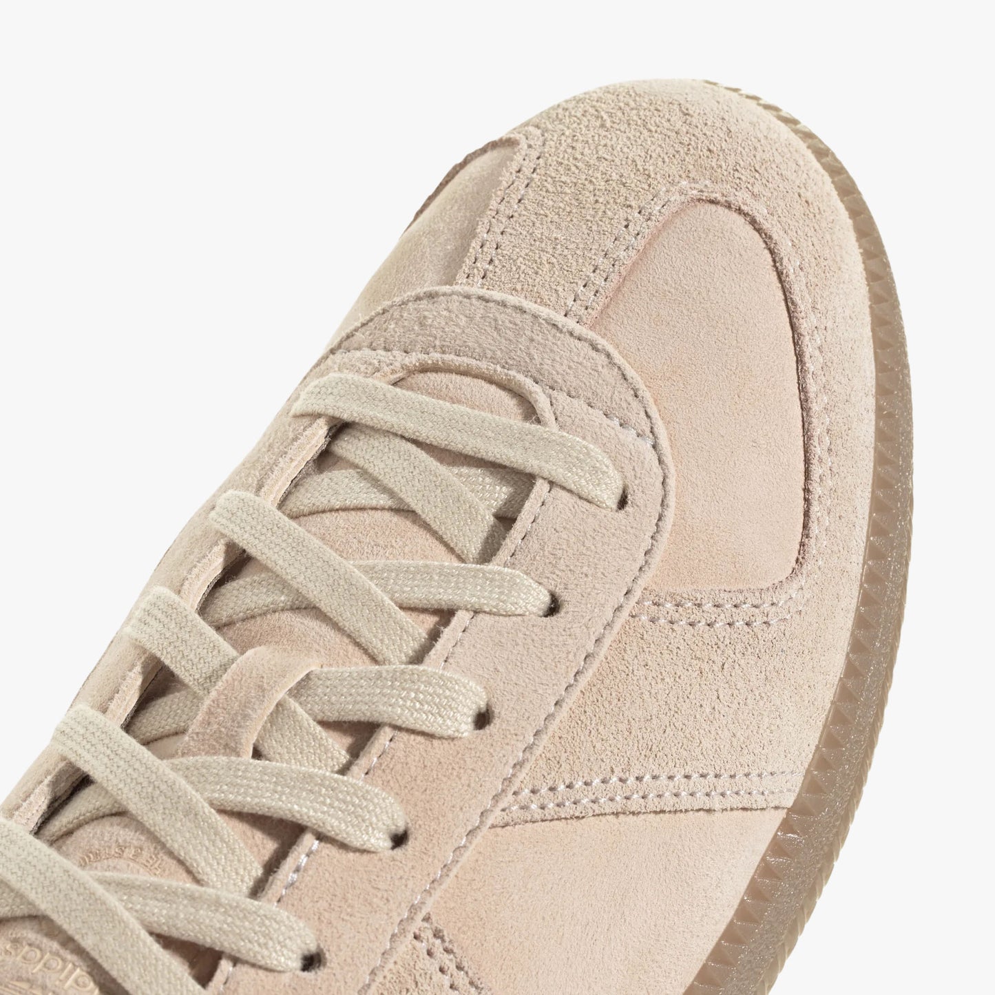 adidas BW Army. Close-up of Halo Blush nubuck T-toe overlay, flat laces, and Gum rubber midsole rim. 