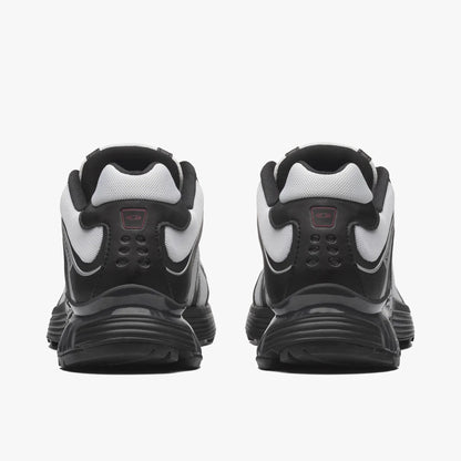 Salomon XT-WHISPER. Rear view of a pair of sneakers displaying black synthetic heel overlays, white collar trimming, red ACS heel insert badges, and black midsoles. 