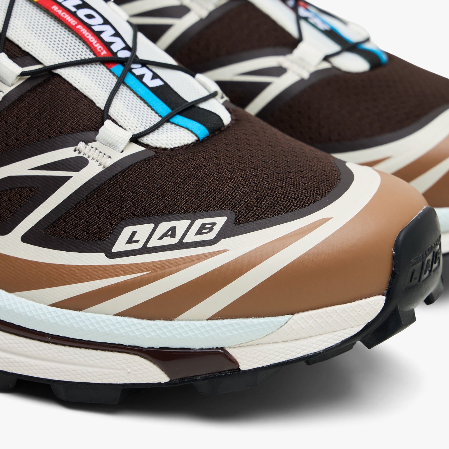 Salomon XT-6 GTX. Close-up of Black Coffee mesh upper, Burro toe cap overlay, and white LAB logo branding. 