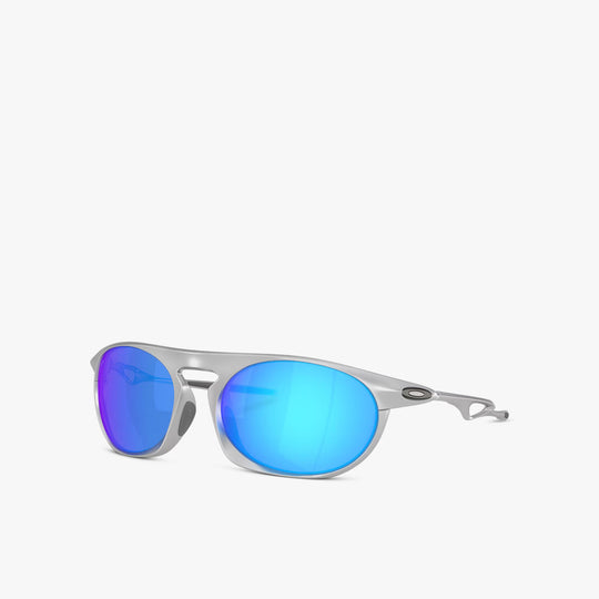 Oakley Neo Jacket. Three-quarter view of satin chrome sunglasses showing metallic frame and blue mirrored lenses. 