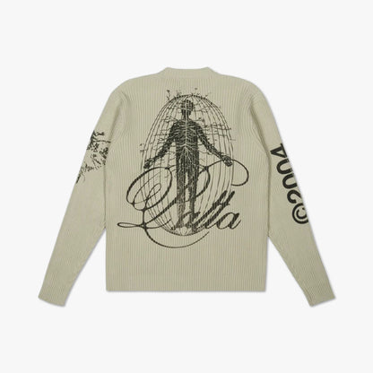 Patta Scorpio Knitted Jumper. Flat lay back view displaying the beige crewneck knit sweater with a large black Vitruvian man anatomical graphic and script logo across the back, along with sleeve graphics on both arms. 