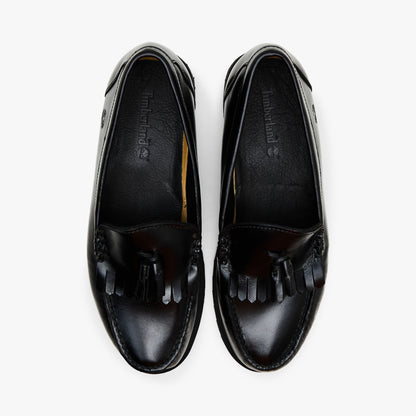 Timberland Authentic Loafer. Top-down view showcasing slip-on silhouette, kiltie fringe across the vamp, leather collars, and dark branded insoles. 
