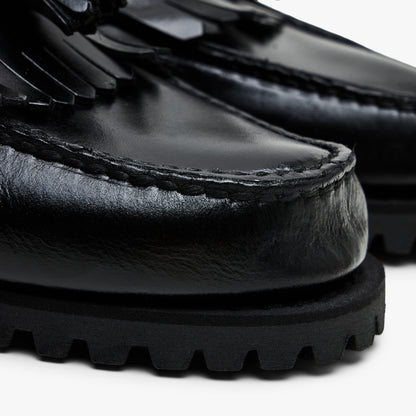 Timberland Authentic Loafer. Close-up view of toe box displaying hand-sewn moc-toe stitch detailing, kiltie fringe overlay, and stacked rubber lug sole. 