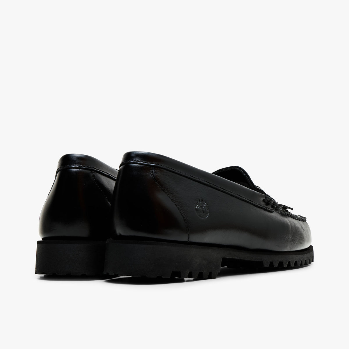 Timberland Authentic Loafer. Back view displaying smooth black leather heel counters, tonal stitching, and raised rubber lug heels. 