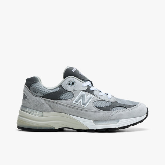 New Balance Made in USA 992. Side view of grey suede and mesh sneakers with white and grey N logo and chunky midsole. 